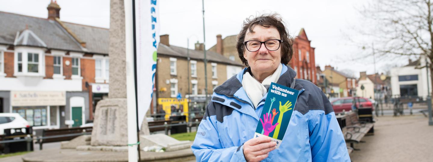 Old lady holding a leaflet